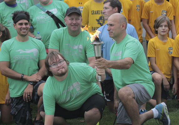 Torch runners beat storm back to the finish line